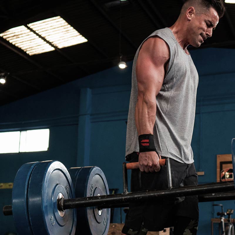 Man lifting a barbell in a gym setting
