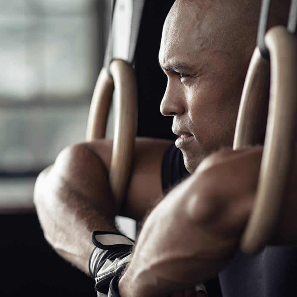 Man exercising on a machine in a gym setting