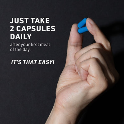 Mans hand holding two blue TestroVax Max capsules