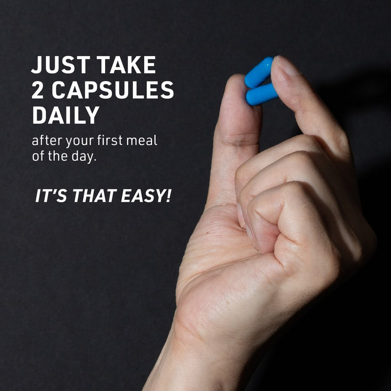 Mans hand holding two blue TestroVax Max capsules