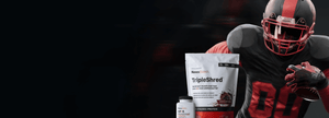 A football player in a black and red uniform holds a football, standing next to a white bag of Novex Biotech Triple Shred protein powder and a small white bottle labeled GF-9 against a dark background.