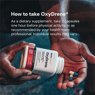 Person holding OxyDrene supplement bottle with capsules in hands, showing usage instructions.