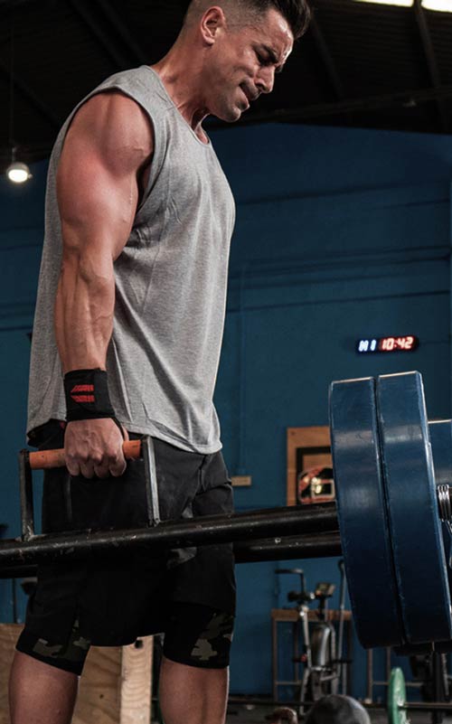 Man lifting a barbell in a gym setting