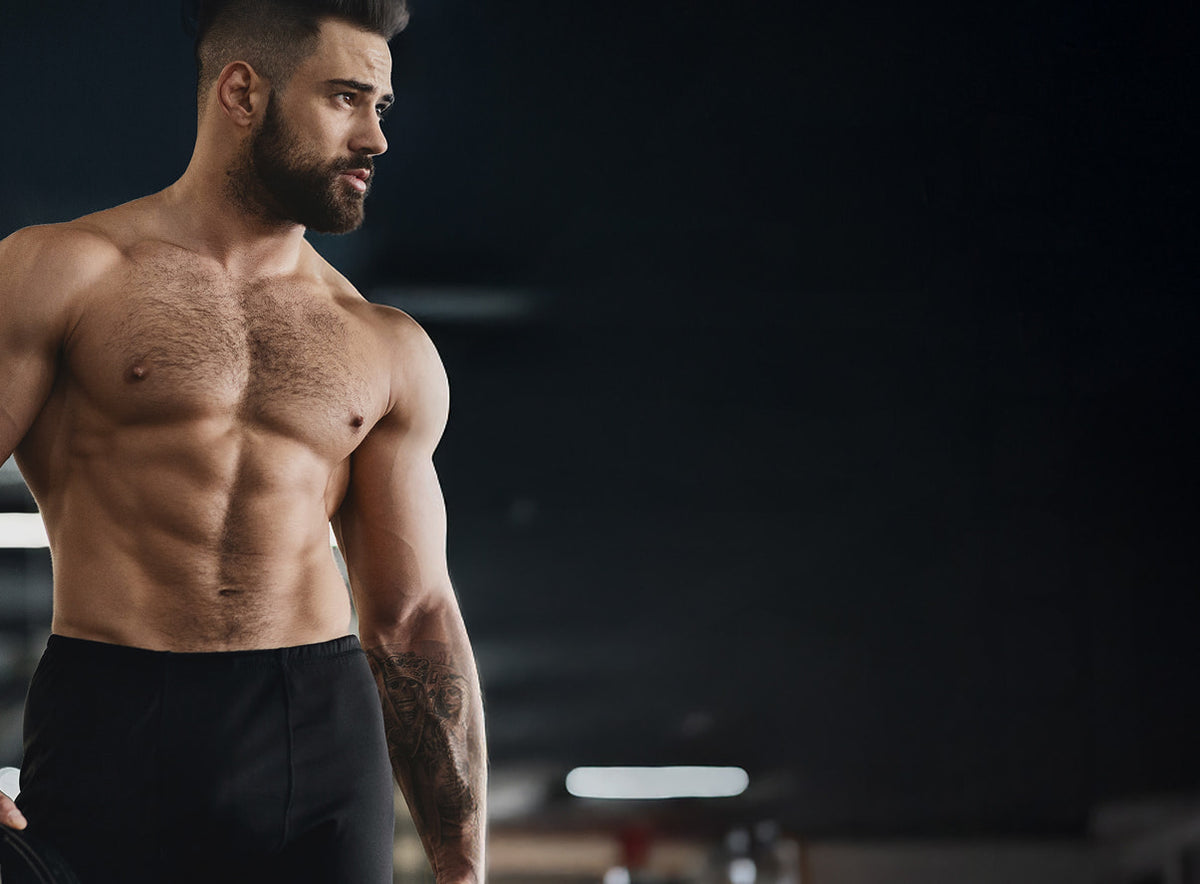 Muscular man with a beard in a gym setting